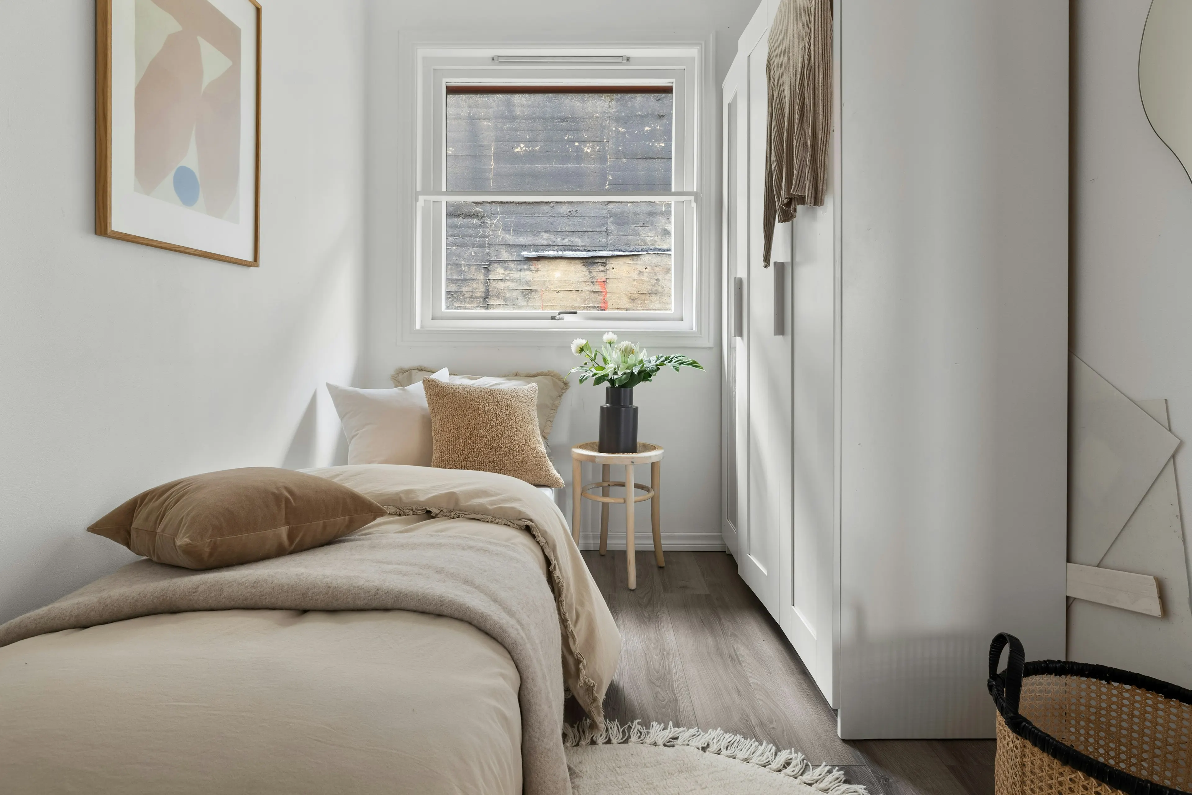 Single bed with beige cushions and white flowers (reference image)